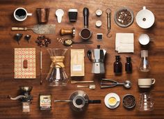 a table topped with lots of different types of kitchen utensils and coffee cups