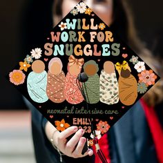 a woman holding a graduation cap that says will work for snuggles