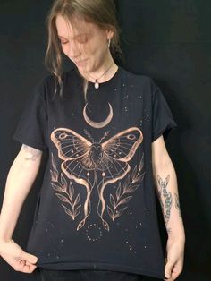 a woman wearing a black shirt with a butterfly on it