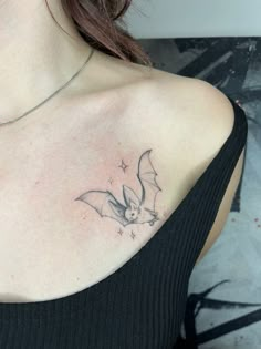 a woman with a bat tattoo on her chest