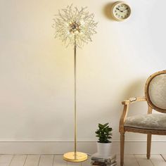 a living room with a chair, clock and lamp on the wall next to it