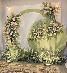 a floral backdrop with roses and greenery for a wedding or special event in front of a wall