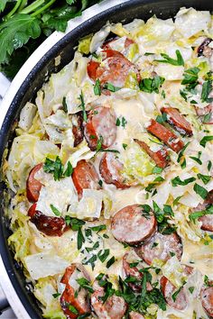 a skillet filled with pasta and sausage