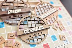 wooden scrabbles with names and numbers are arranged on a game board as if they were made out of wood