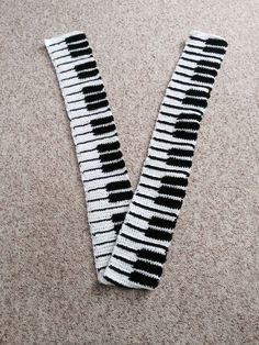 a pair of black and white socks laying on top of a carpet next to each other