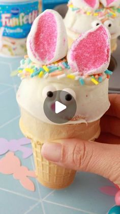 someone is holding an ice cream cone with bunny ears on it