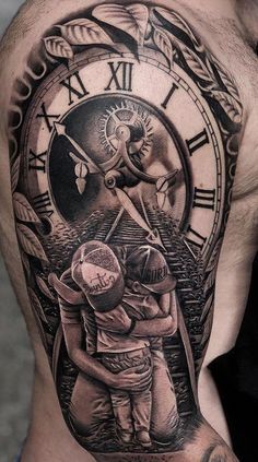 a man with a clock tattoo on his shoulder and chest is holding a child in front of him