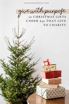 presents stacked on top of each other in front of a christmas tree