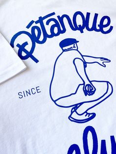 a white tshirt with blue print on the front and bottom that says patanque since