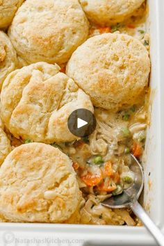 a casserole dish with chicken pot pies and biscuits in it, ready to be eaten