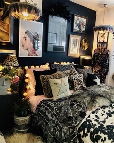 a black and white bedroom with pictures on the wall, leopard print bedding and pillows