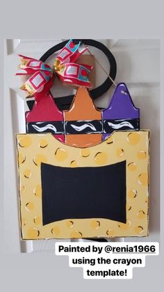 a door hanger that has some candy in the shape of a boat on it