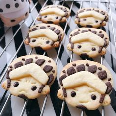 some cookies with chocolate chips and white frosting are sitting on a rack next to a stuffed animal