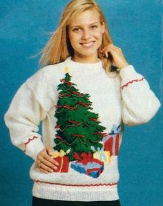 a woman wearing a christmas sweater with a tree on it