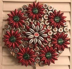 a red and white wreath made out of bottle caps