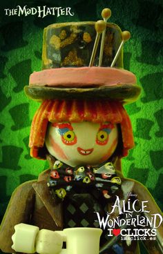 the doll is wearing a top hat and holding a small item in her hand,