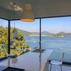 a kitchen with a large window overlooking the water