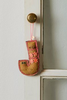 the door handle is decorated with an image of a boot hanging on it's side