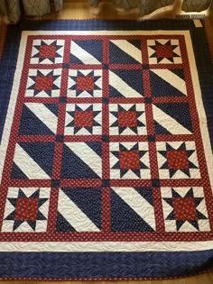 a red, white and blue quilt with stars on it