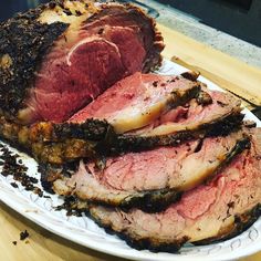 sliced roast beef on a plate sitting on a table