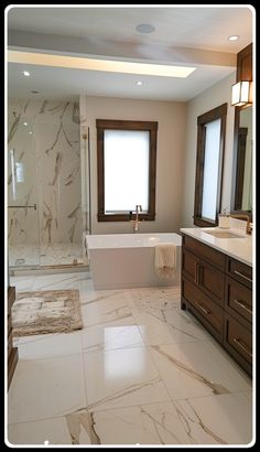 a large bathroom with marble floors and white walls, along with a tub in the middle