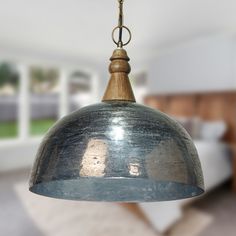 a metal light hanging from a ceiling in a room