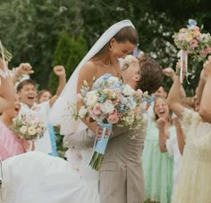 the bride and groom are surrounded by their wedding party