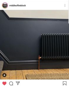 a black radiator in the corner of a room