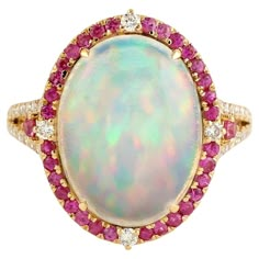 This ring has been meticulously crafted from 14-karat gold. It is hand set with 3.68 carat Ethiopian opal, .55 carats pink sapphire & .25 carats of sparkling diamonds. The ring is a size 7 and may be resized to larger or smaller upon request. FOLLOW MEGHNA JEWELS storefront to view the latest collection & exclusive pieces. Meghna Jewels is proudly rated as a Top Seller on 1stDibs with 5 star customer reviews. All items manufactured by us are handmade and can be customized or redesigned. Composit Elegant Multicolor Opal Ring, Pink Opal Ring Fine Jewelry, Elegant Multicolor Cabochon Opal Ring, Elegant Pink Opal Gemstone Ring, Formal Pink Oval Opal Ring, Pink Oval Cabochon Opal Ring, Vintage Cocktail Ring, Sapphire Diamond Ring, Top Seller