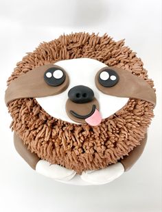 a cake decorated to look like a hedge with eyes, nose and hands on it