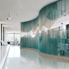 an indoor swimming pool surrounded by glass walls