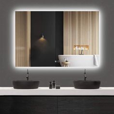 a bathroom with two sinks and a large mirror above the sink that has lights on it