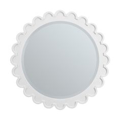 a round mirror with scalloped edges on a white background