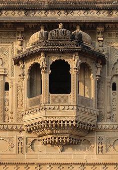 an ornate building with intricate carvings on the side