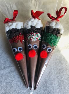 three chocolate covered candy sticks decorated like reindeers