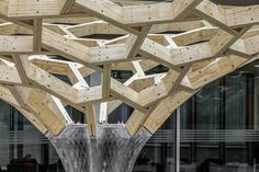 a sculpture made out of wooden planks in front of a building