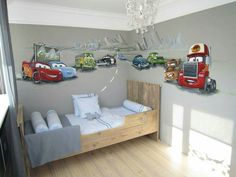 a child's bedroom with cars painted on the wall