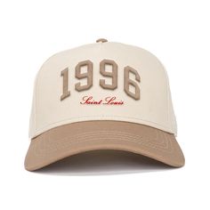 a white and tan hat with the words 1989 printed on it