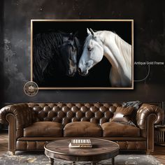 two white horses standing next to each other in front of a black wall and brown leather couch