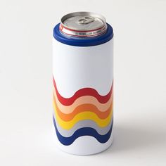 a white can with an orange, yellow, and blue stripe on the bottom is sitting in front of a white background