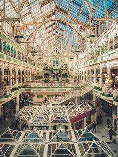 the inside of a shopping mall with multiple floors and glass ceilinged structures on each floor