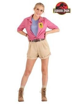 a woman in pink shirt and tan shorts standing with her hands on her hips while wearing brown boots