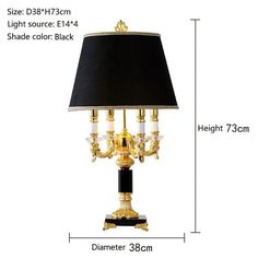 a gold and black table lamp with a black shade on the bottom, and measurements for it