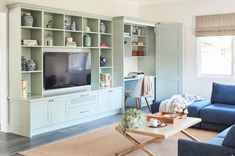 a living room filled with furniture and a flat screen tv