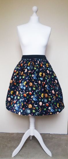 Gathered  full skirt made from a beautiful 100% cotton, navy Planets fabric. Each skirt is made by gathering the fabric onto  a 2 inch black elastic waistband. The length measures from the top of the waistband and comes in three lengths, 19", 22" or 25". Please choose length from the drop down menu. The waist measurement can be seen in the measurement guide below. Please choose waist size from the drop down menu. The skirt is pictured with a petticoat to show its potential fullness, which is not Space Skirt, 50s Skirt, 1950s Skirt, Spring Floral Prints, Space Fabric, Space Outfit, Full Circle Skirt, Space Gift, Quirky Fashion