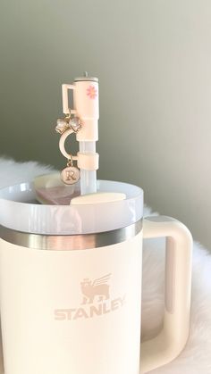 a white blender sitting on top of a fur covered floor