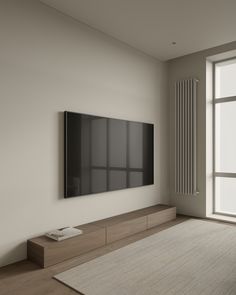 an empty room with a large flat screen tv on the wall