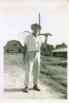 an old black and white photo of a man holding a baseball bat