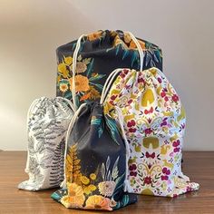 three bags sitting on top of a wooden table