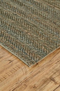 a close up view of a wooden floor with a rug on it's side